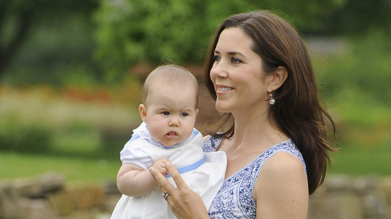 Princess Mary of Denmark holds baby Princess Josephine in 2011