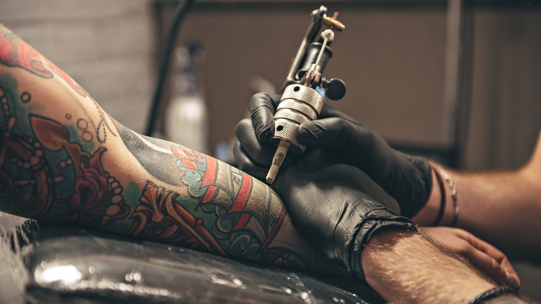 a tattoo artist hard at work