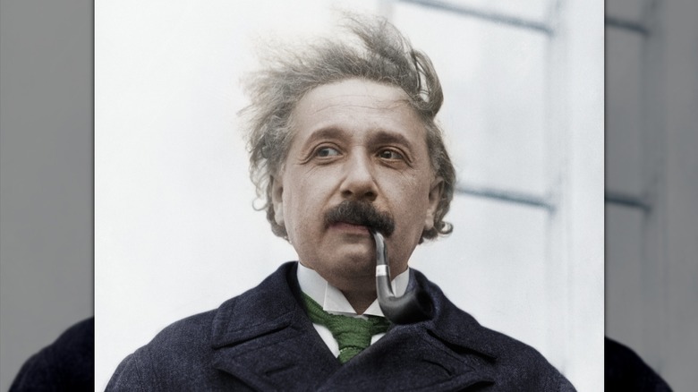 Albert Einstein posing with a pipe in his mouth