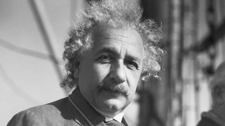 Albert Einstein looks into the camera lens in a close-up black-and-white photo