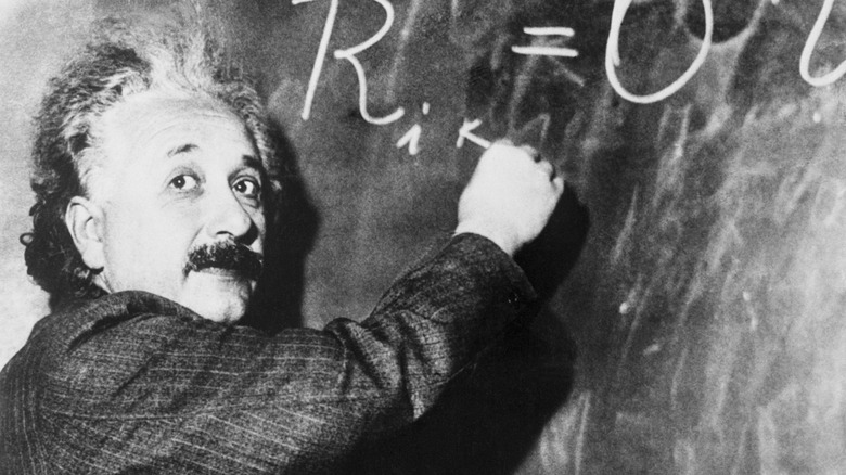 Albert Einstein writing an equation on a blackboard at the California Institute of Technology