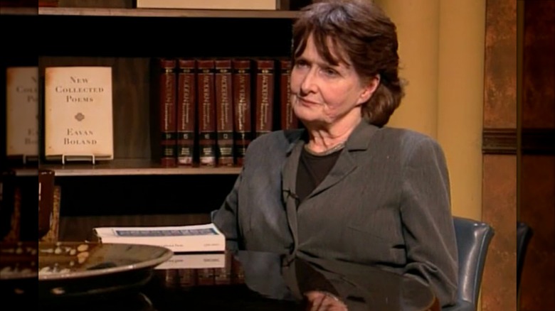 Eavan Boland sitting alongside her poetry book