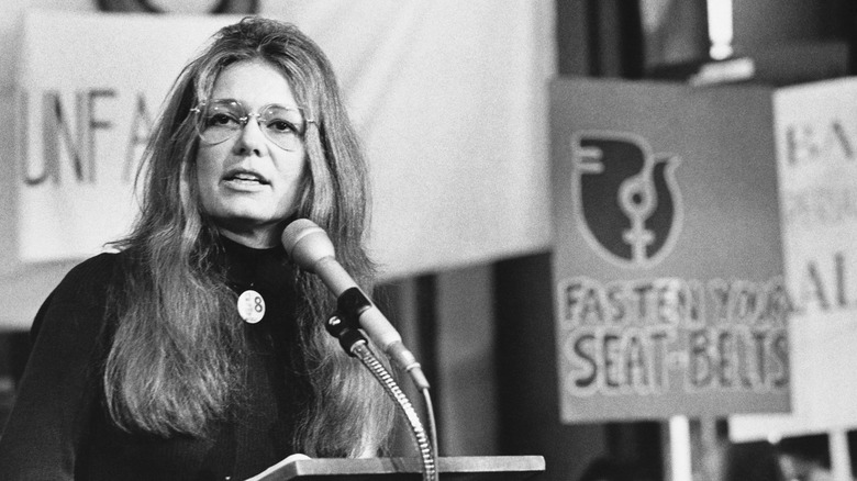 Gloria Steinem speaking into microphone