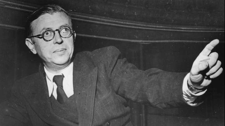 Philosopher Jean-Paul Sartre holding an arm out and pointing, circa 1946