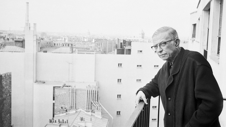 Jean-Paul Sartre on a balcony looking in the distance