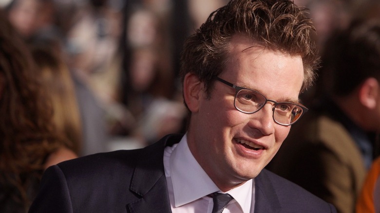 John Green smiling and looking off to the side