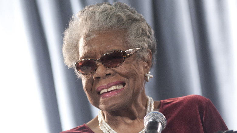 Maya Angelou smiling and talking at a microphone