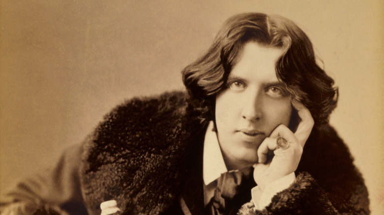 Oscar Wilde posing for a photo
