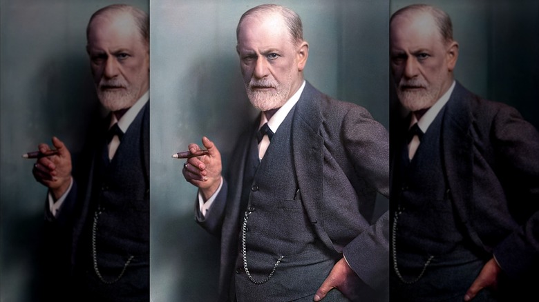 Sigmund Freud holding a cigar and scowling