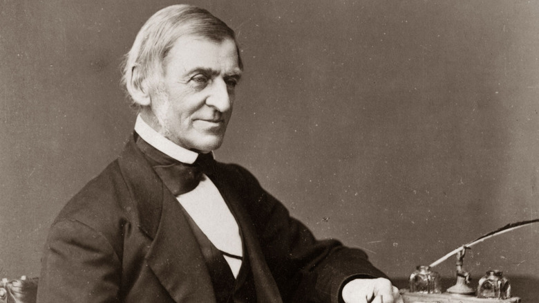 Ralph Waldo Emerson sitting at a desk