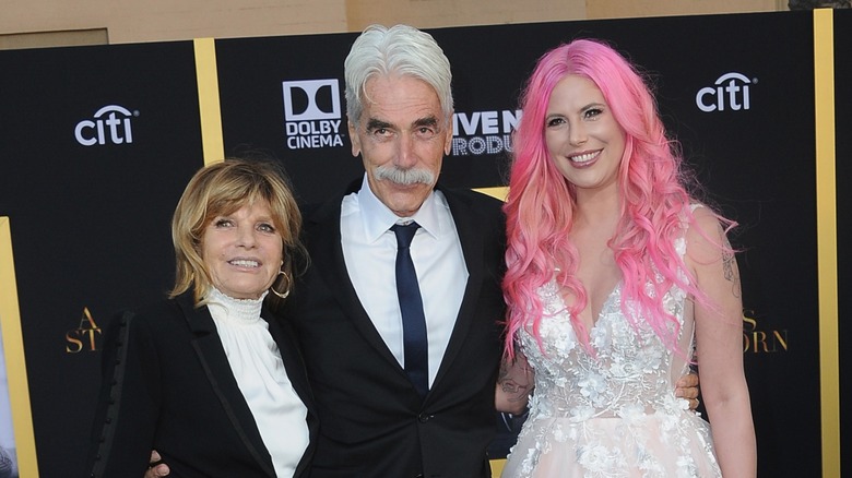 Katharine Ross, Sam Elliott, and Cleo Rose Elliot posing together at a red carpet event.