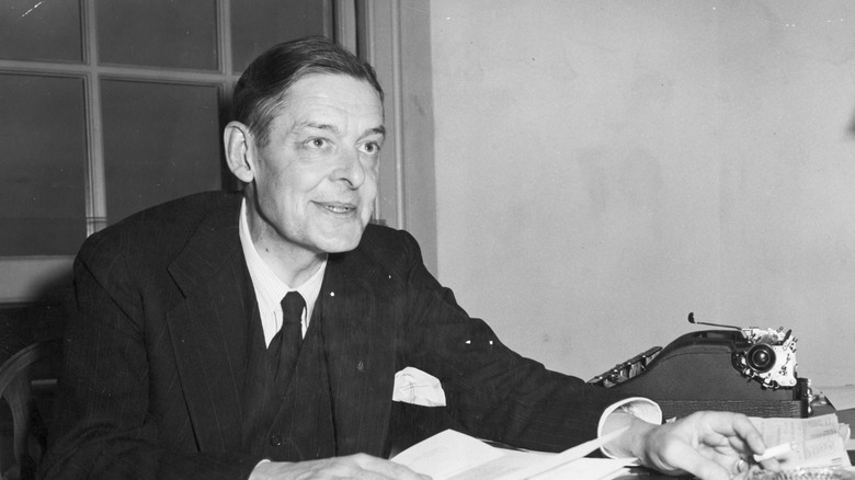 A photograph of T.S. Eliot inspecting manuscripts