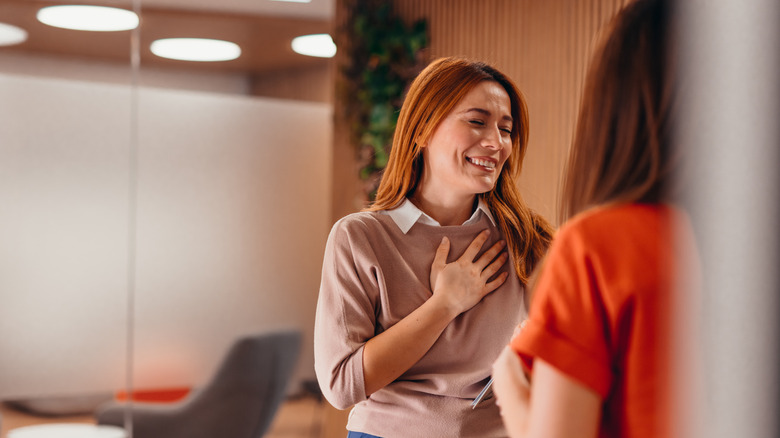 Two woman photographed talking and laughing together