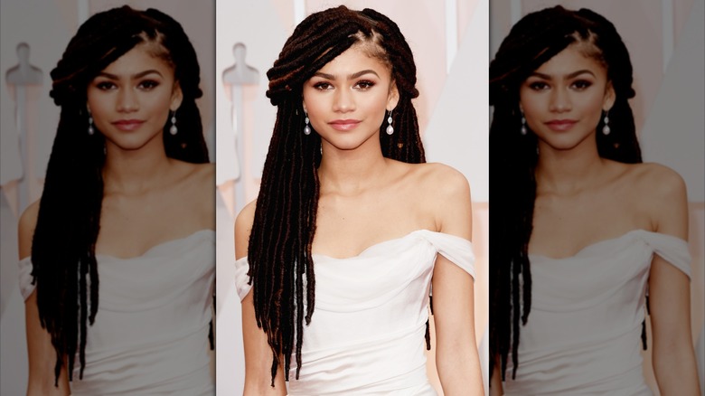 Zendaya in 2015 wearing a white strapless dress and her hair in long dreadlocks