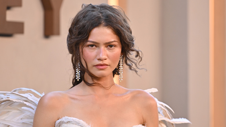 Closeup of Zendaya wearing a white strapless gown with wings