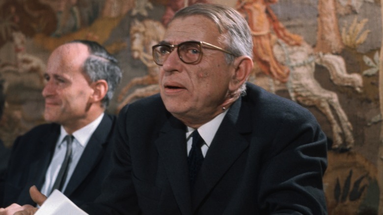 Close-up of Jean-Paul Sartre seated at a table