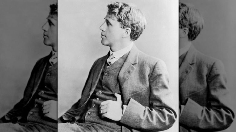 Robert Frost sitting on a chair as a young man