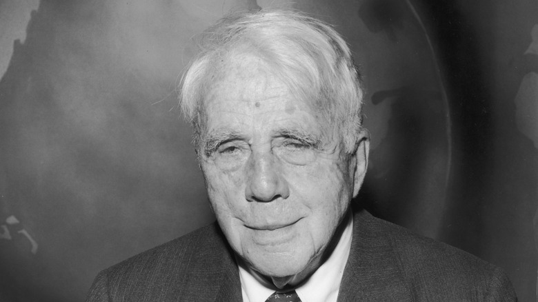 Robert Frost in front of a globe backdrop