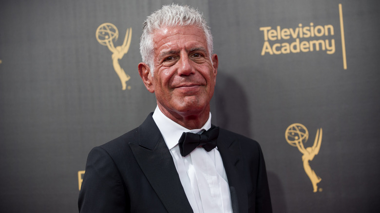 Anthony Bourdain posing for photos in a tuxedo