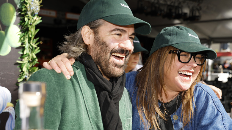 Rachael Ray arm with John M. Cusimano laughing and wearing matching hats