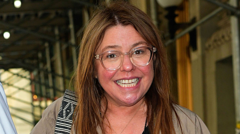 Rachael Ray smiling in clear frame glasses
