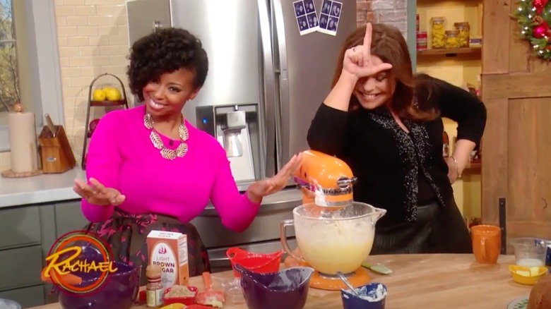 Rachael Ray drops measuring cup into stand mixer on the "Rachael Ray Show" in 2015