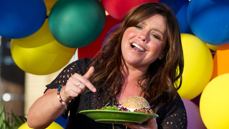 Rachael Ray pointing to a plate of food