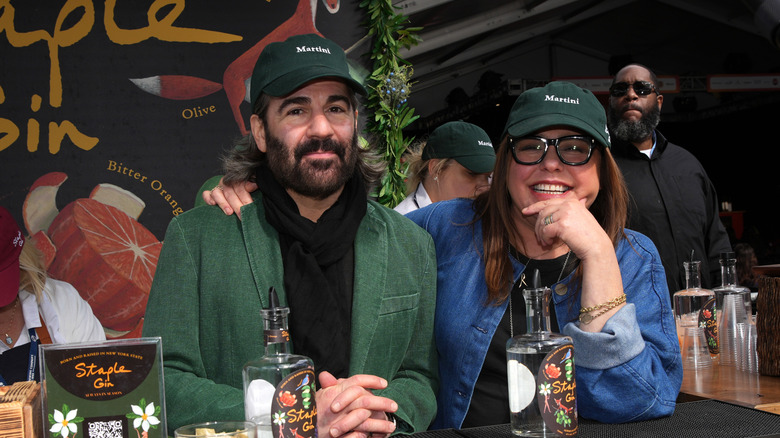 Rachael Ray and her husband John Cusimano sitting together at a table