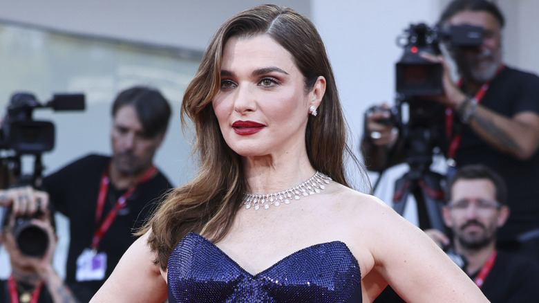 Rachel Weisz posing on the red carpet in a strapless, glittery navy dress