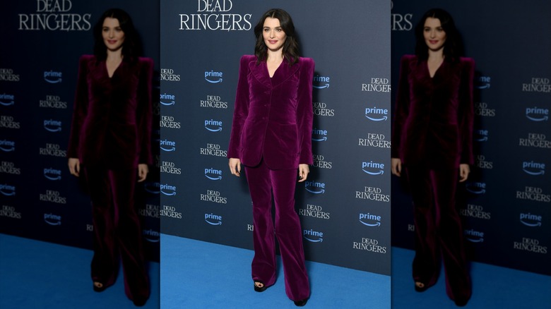 Rachel Weisz posing in a violet suit