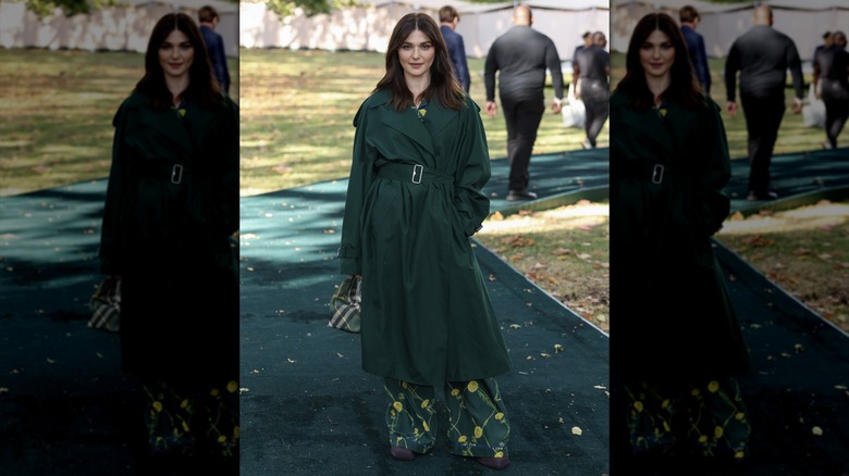 Rachel Weisz posing in a green coat at a fashion show