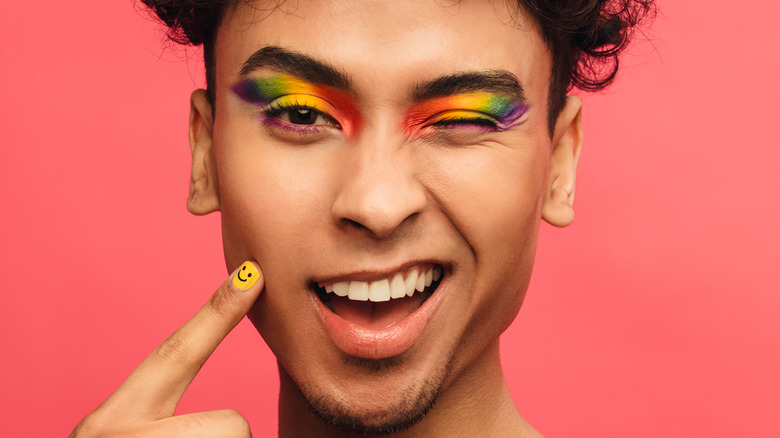 Man winking with rainbow eyeshadow for pride 