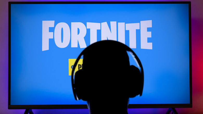 person watching TV with Fortnite logo