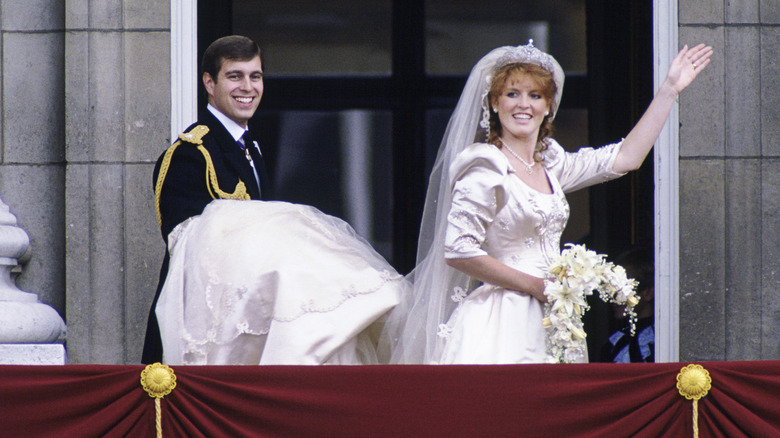 Prince Andrew holding Sarah Ferguson's wedding dress
