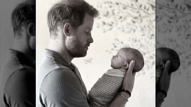 Prince Harry holding baby Princess Lilibet