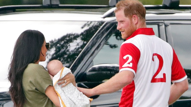 Meghan Markle and Prince Harry holding Archie