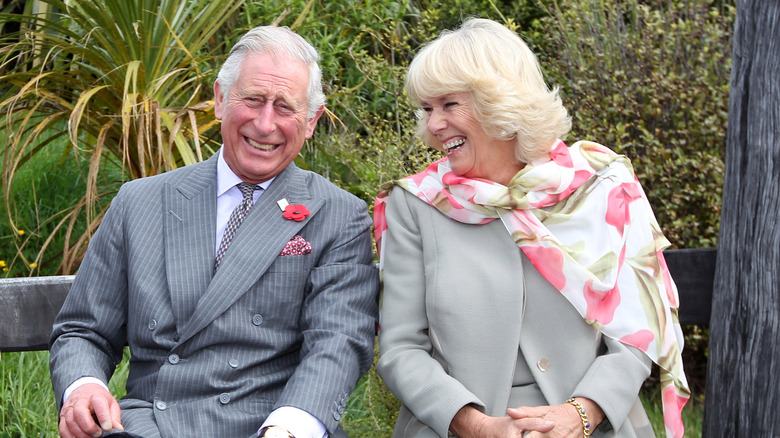 King Charles and Queen Camilla laughing 