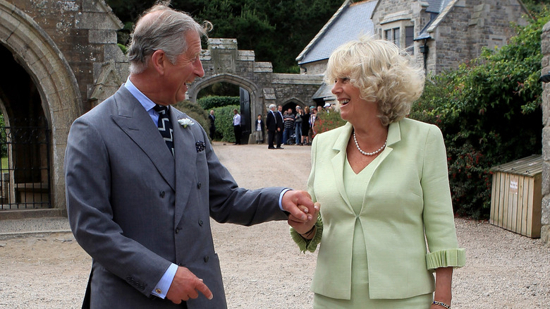 King Charles and Queen Camilla holding hands
