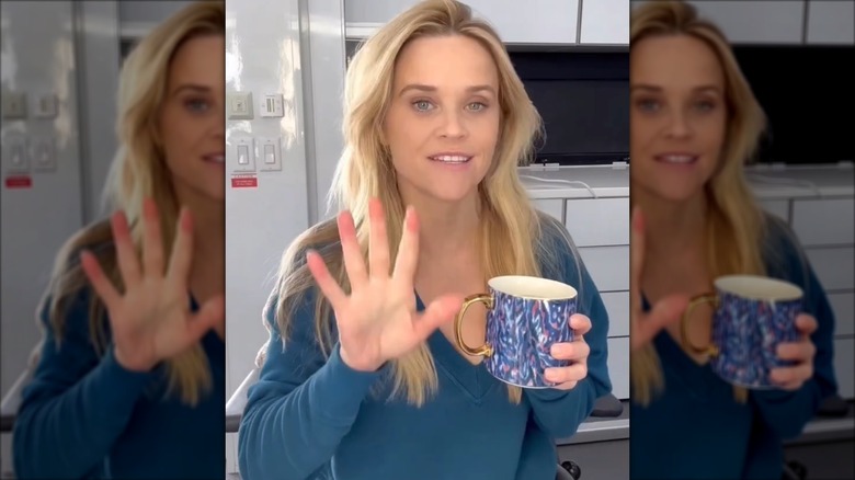 Reese Witherspoon talking with a mug