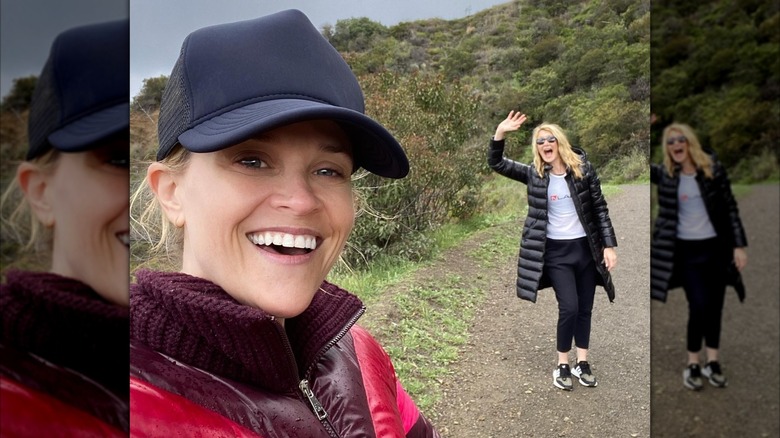 Reese Witherspoon smiling with Laura Dern waving in the background