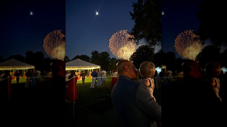 Nicholas Riccio watches fireworks with son Niko