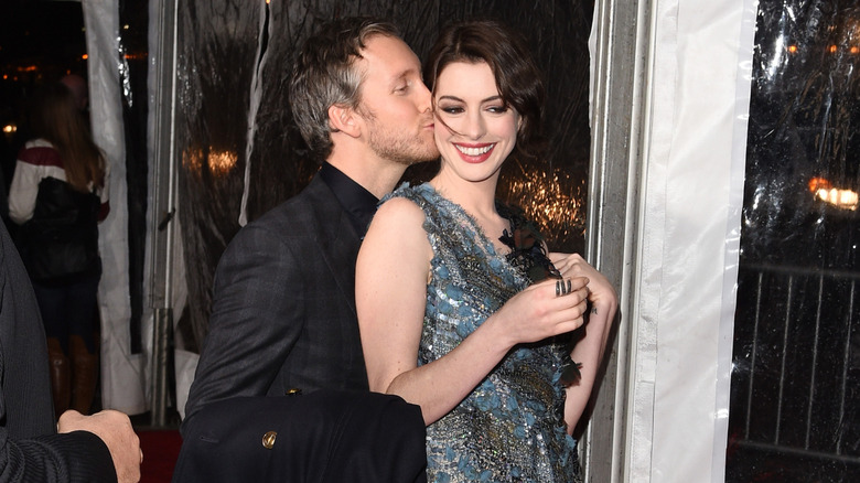 Adam Shulman kissing Anne Hathaway's cheek