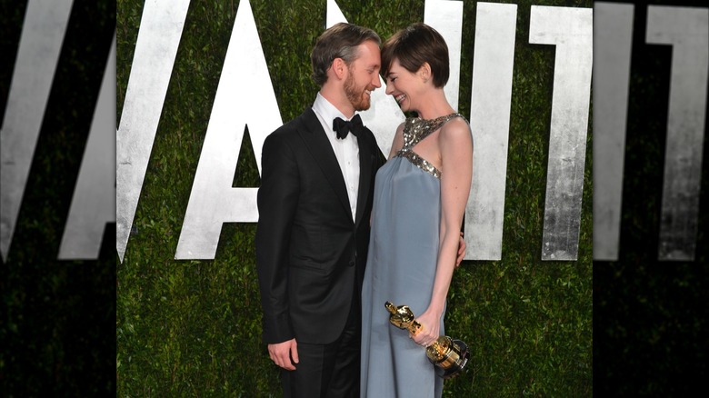 Adam Shulman and Anne Hathaway touching foreheads