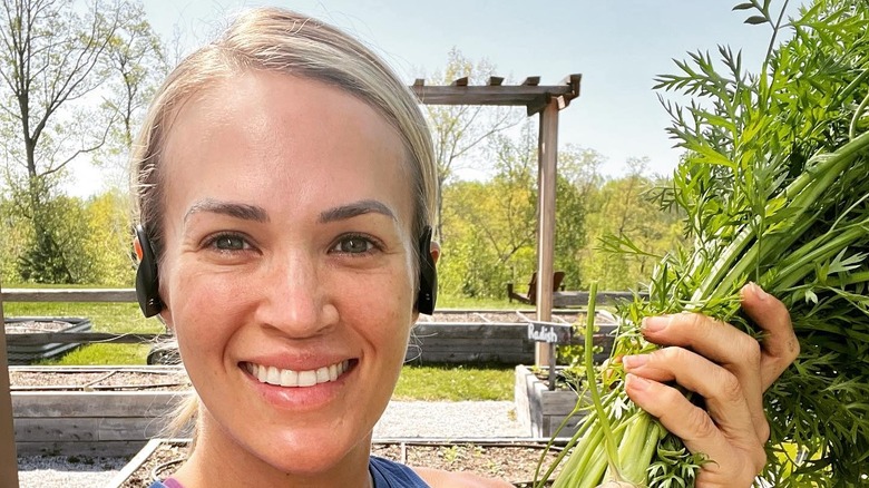 Carrie Underwood smiles while in the garden.