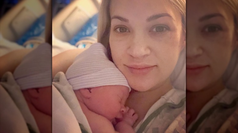 Carrie Underwood holds her newborn son in the hospital