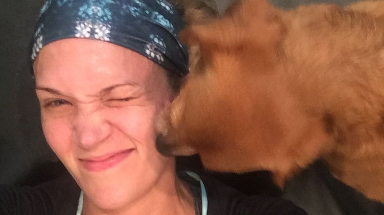 Carrie Underwood getting kissed by a dog.