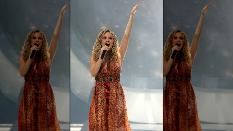 Carrie Underwood singing into microphone