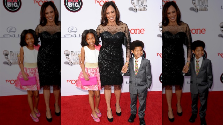 Kamala Harris smiling an posing for photo with children
