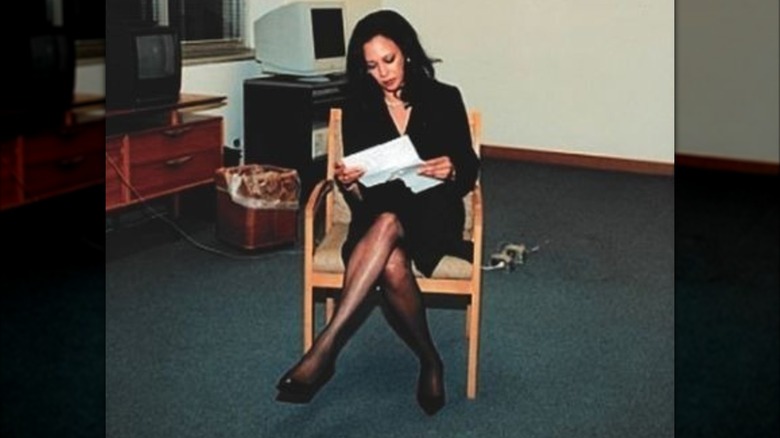 Kamala Harris sitting in a chair with legs crossed