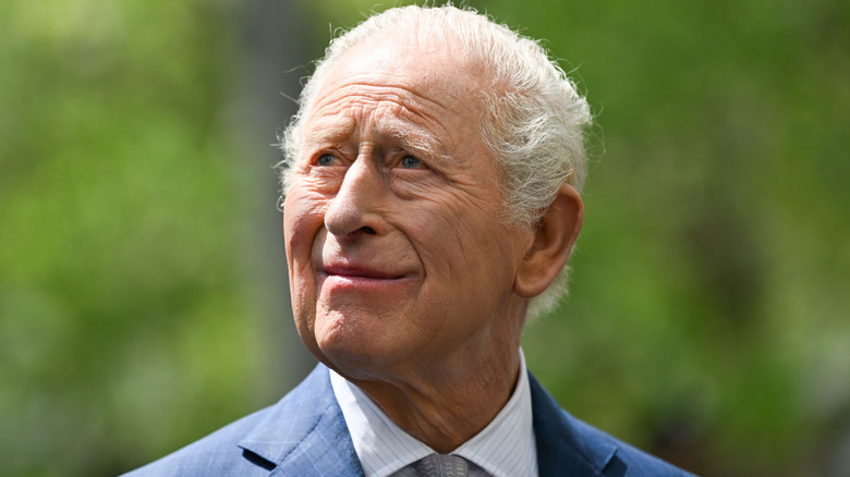King Charles looking upwards and smiling